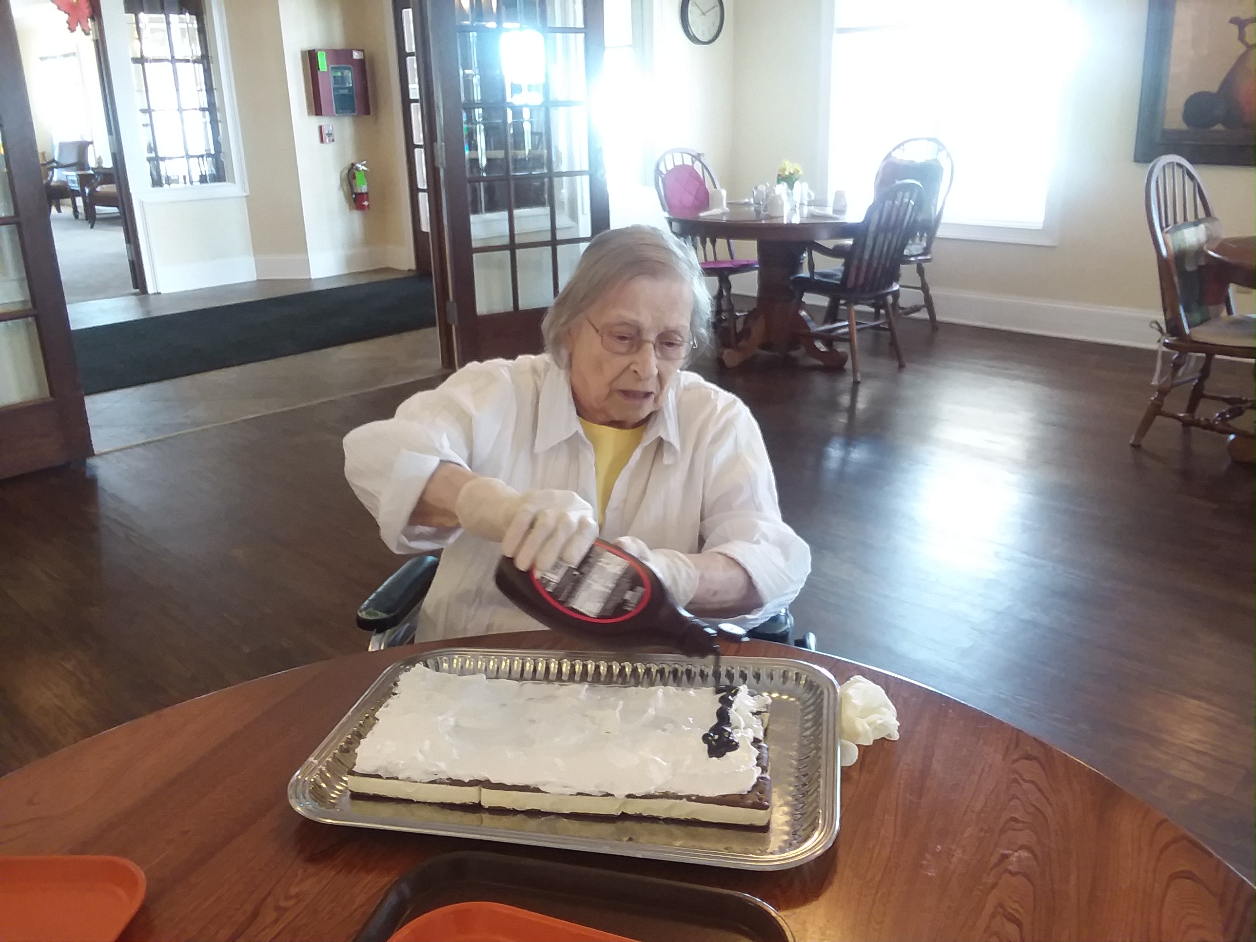 woman decorating ice cream sandwich cake