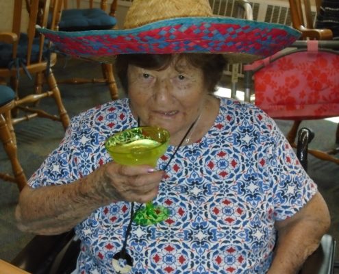woman in sombrero drinking at cinco de mayo party