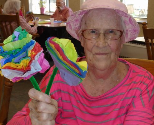 woman smiling with paper flowers