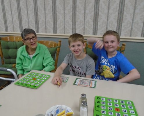 children and seniors playing bingo