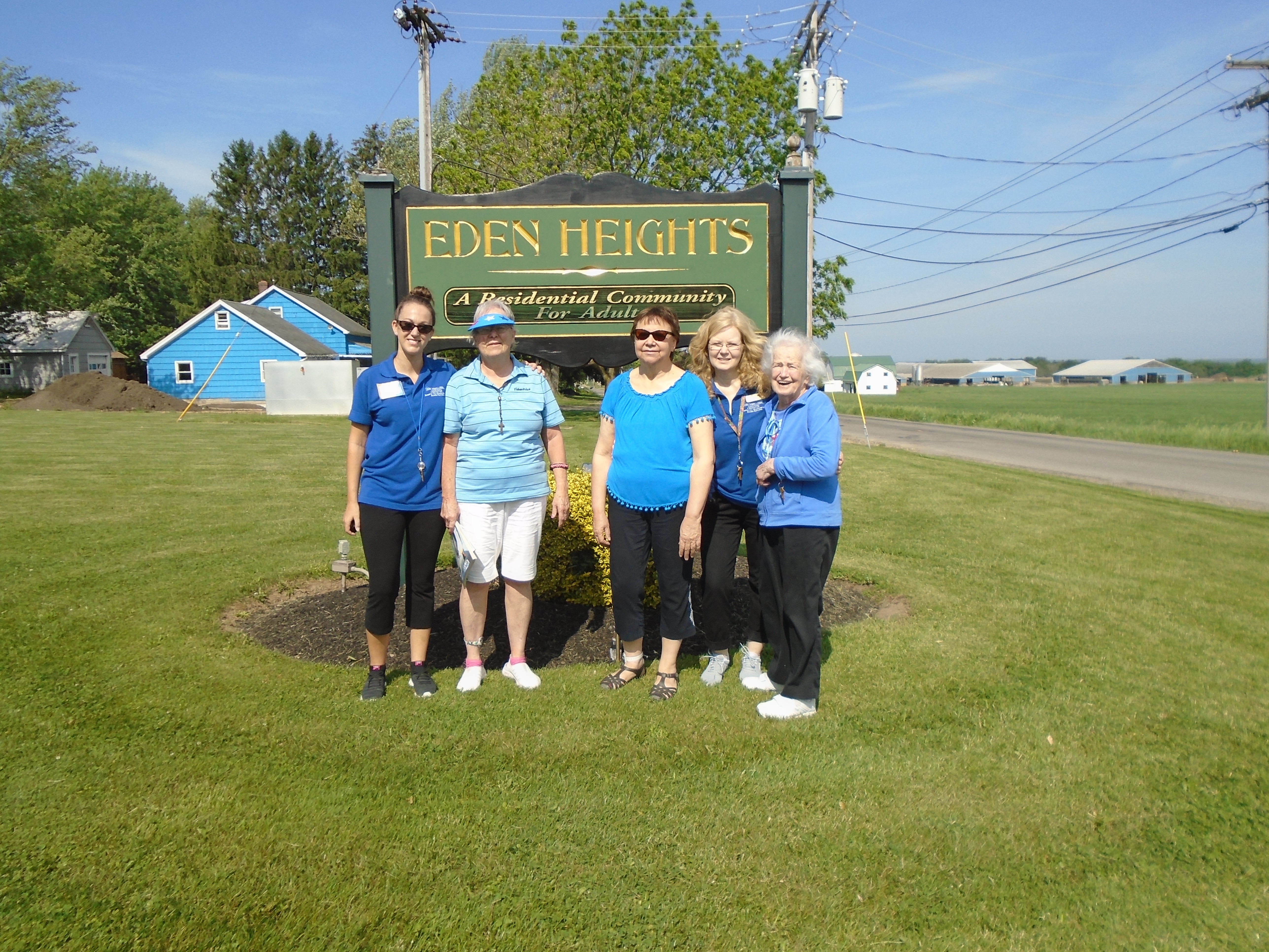 women smiling by eden heights sign