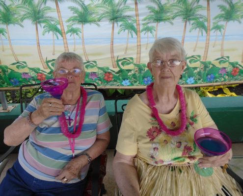 women holding drinks at luau