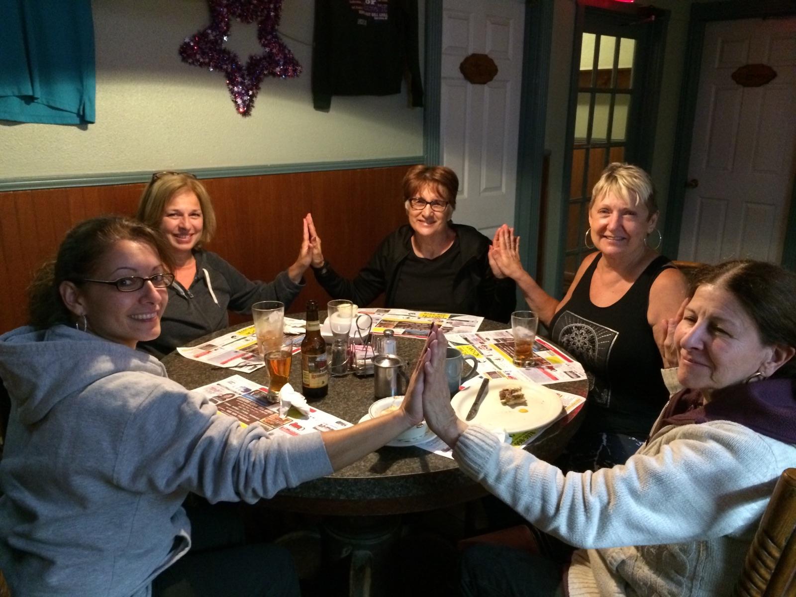 women smiling at dinner