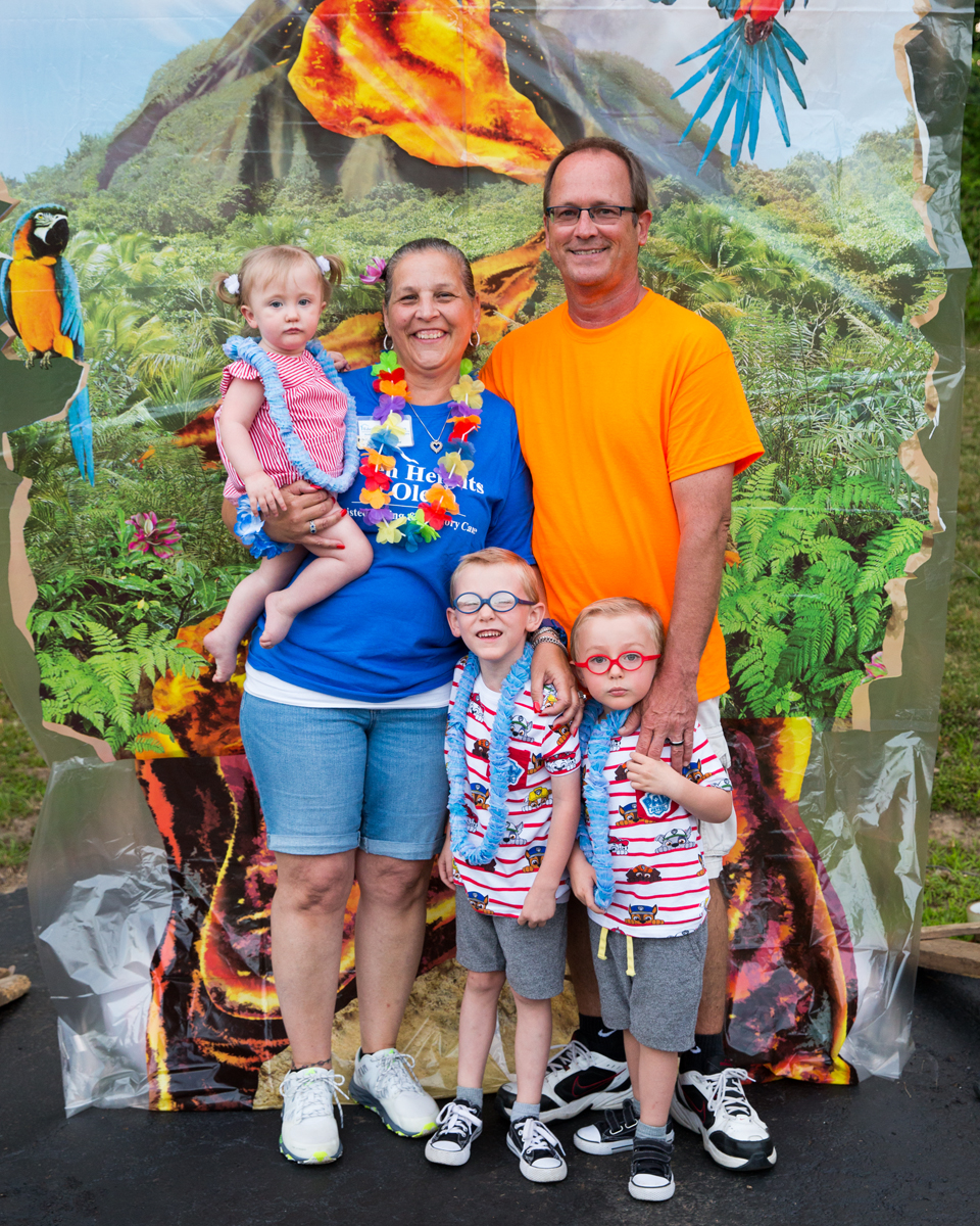 family smiling at luau