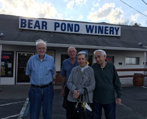 group smiling at winery