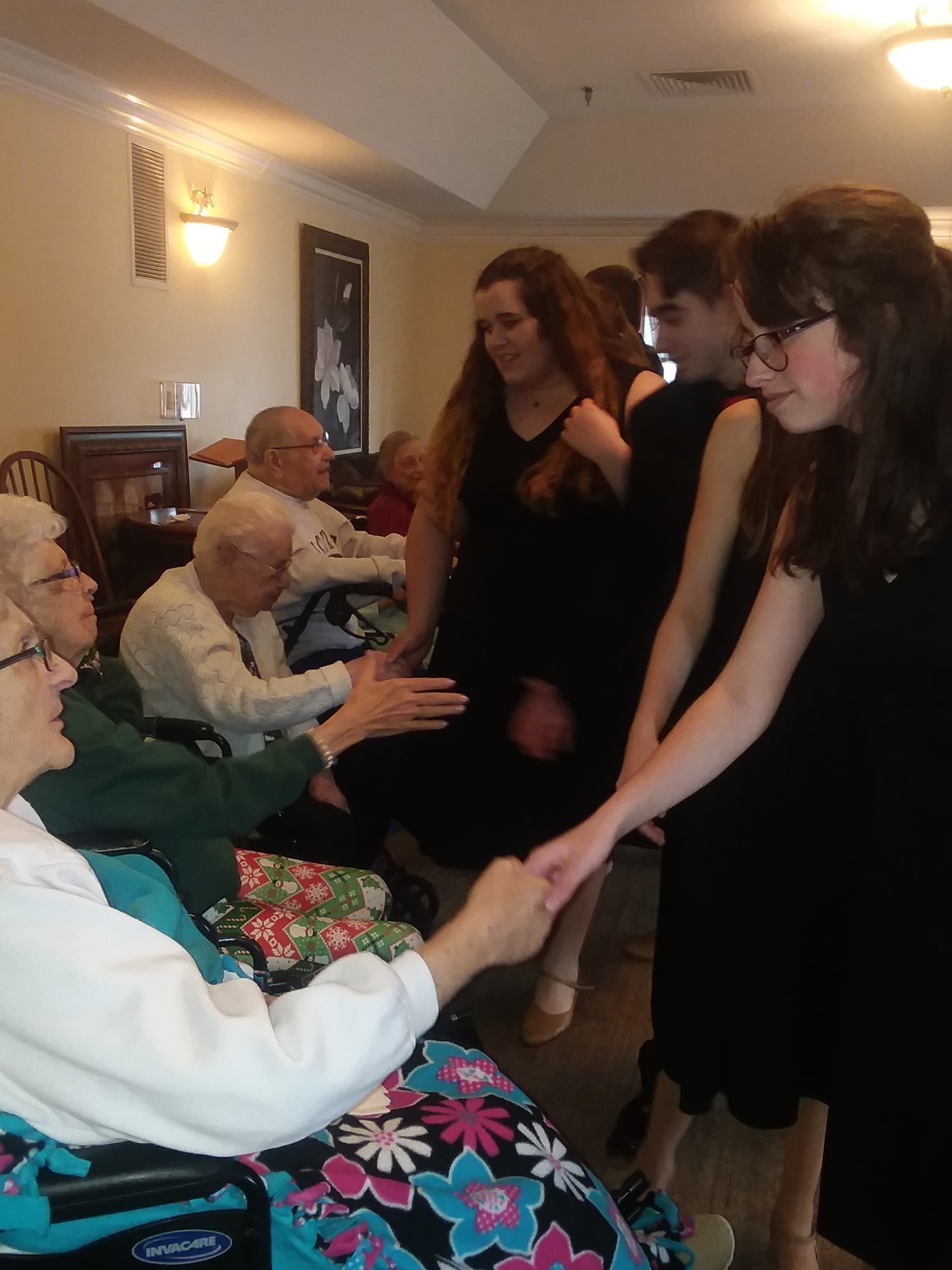 students and seniors shaking hands