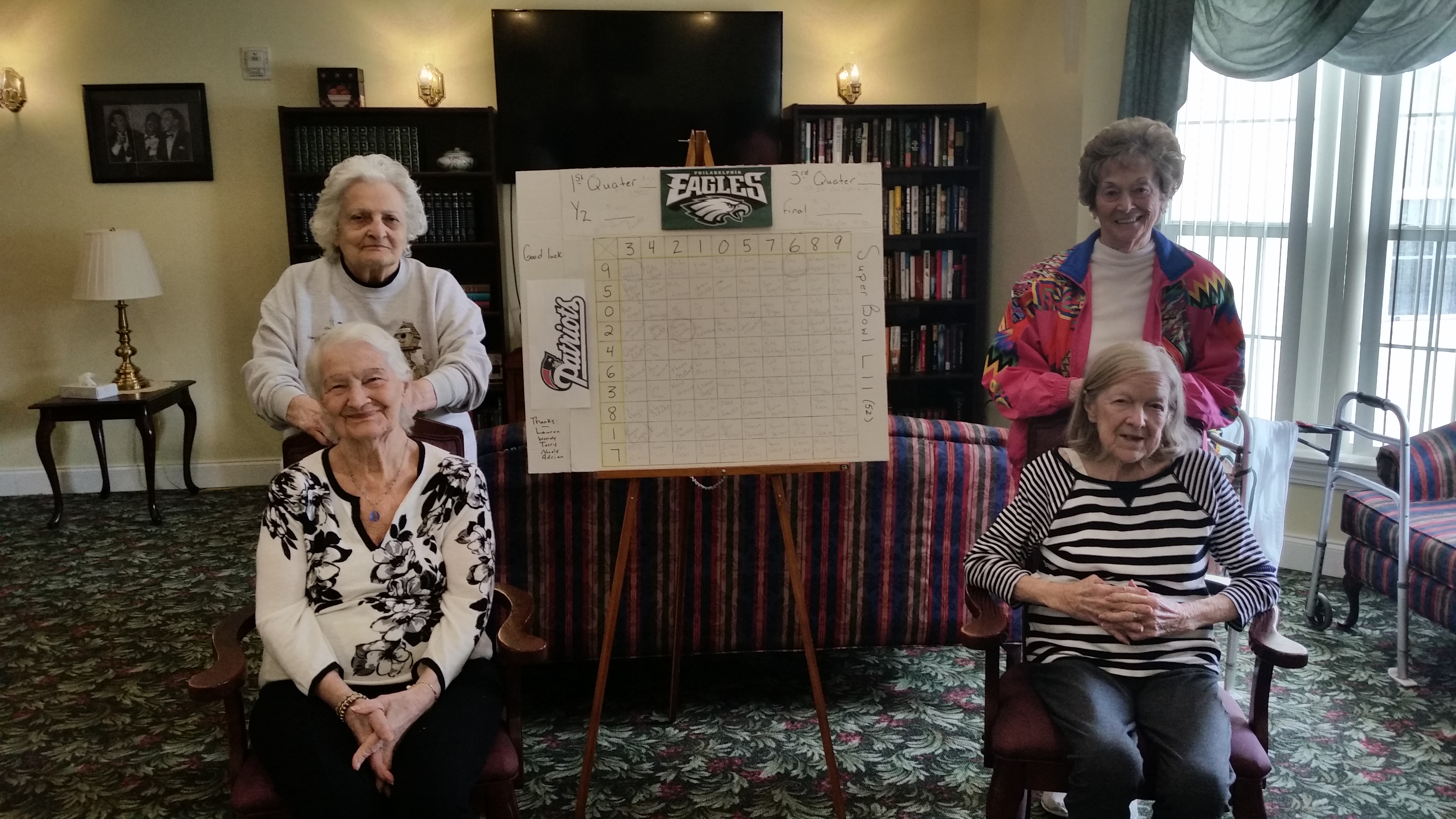 women smiling with super bowl scoreboard