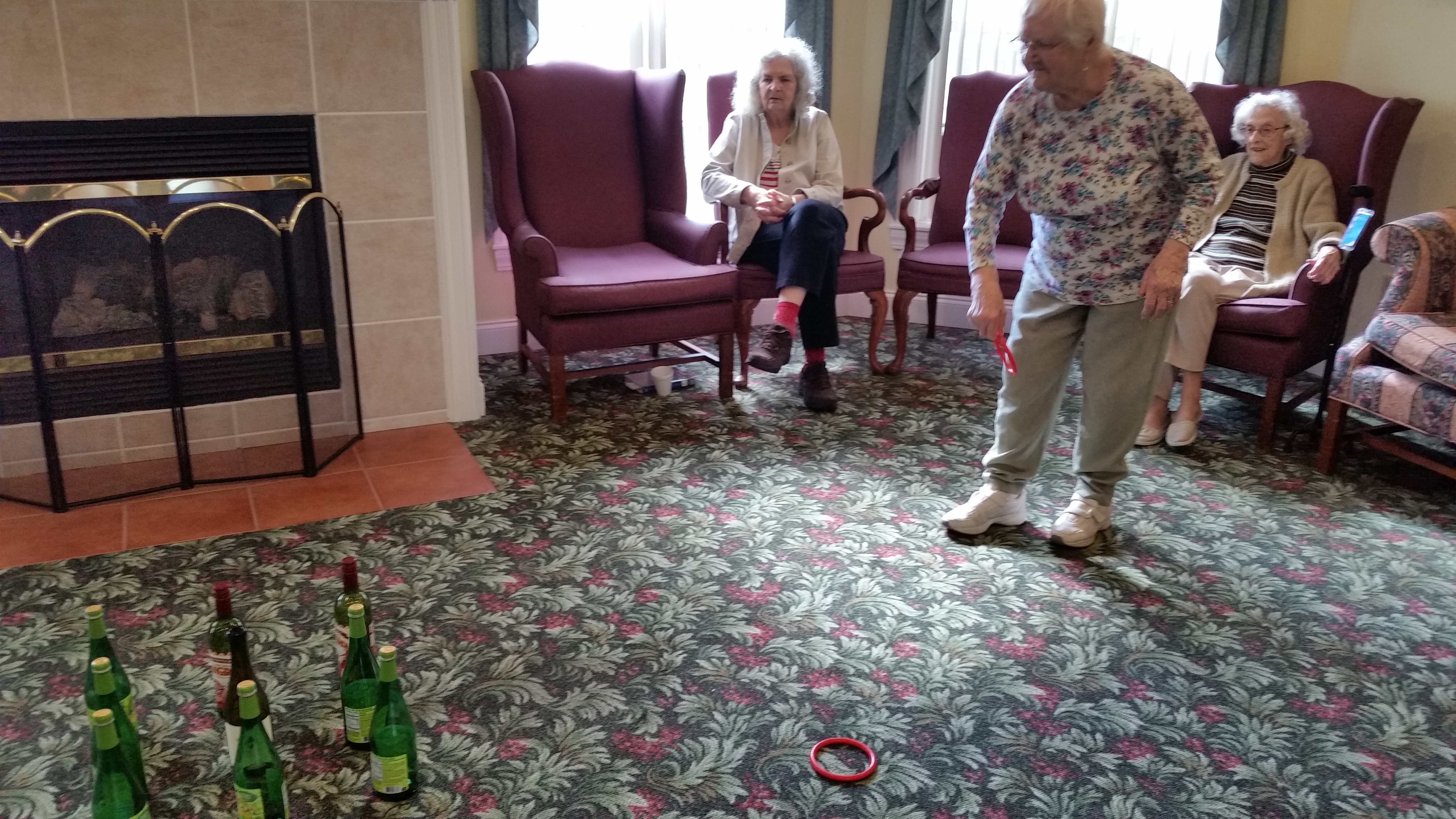 woman tossing ring at bottles