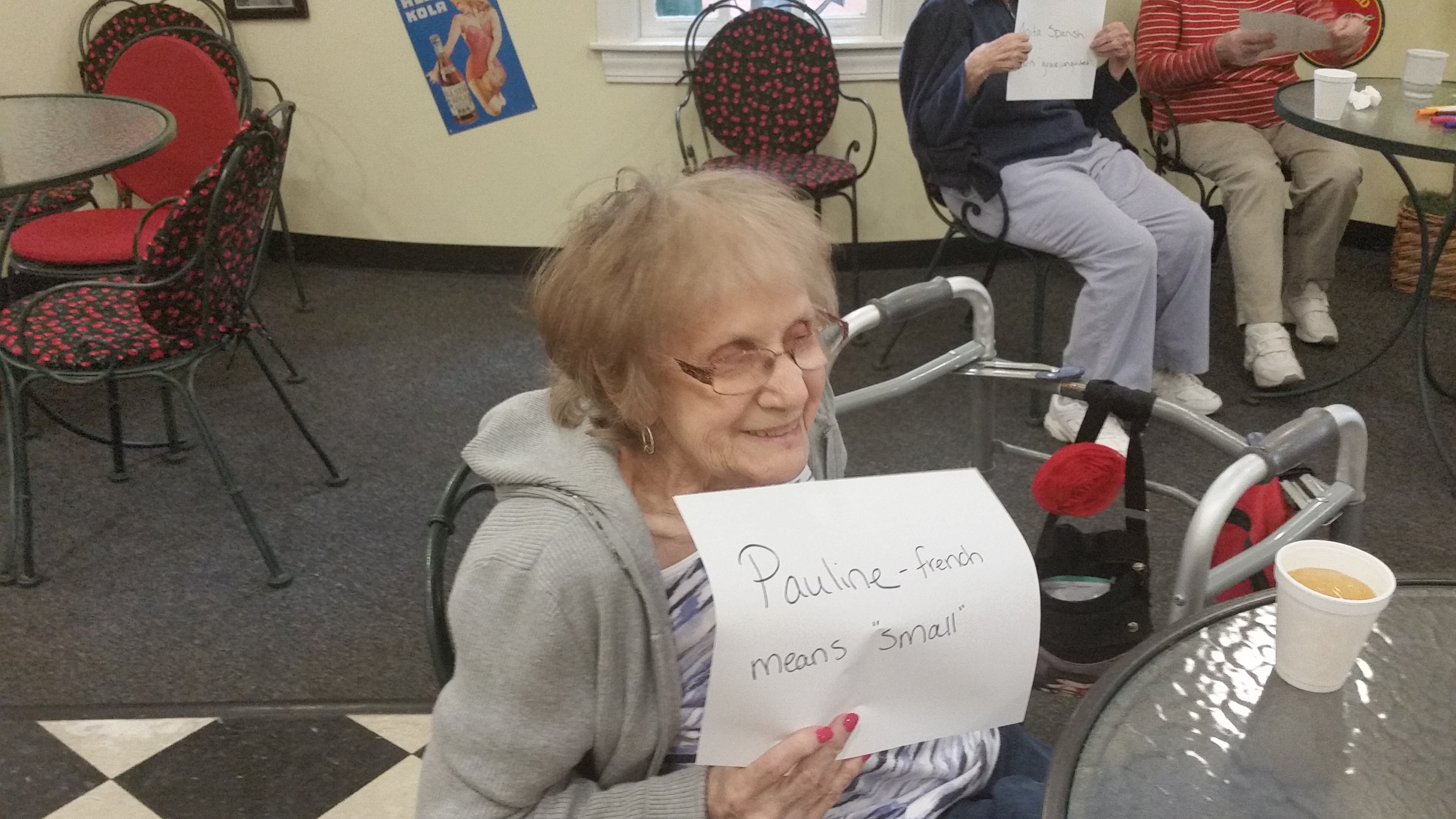 woman holding paper with her name