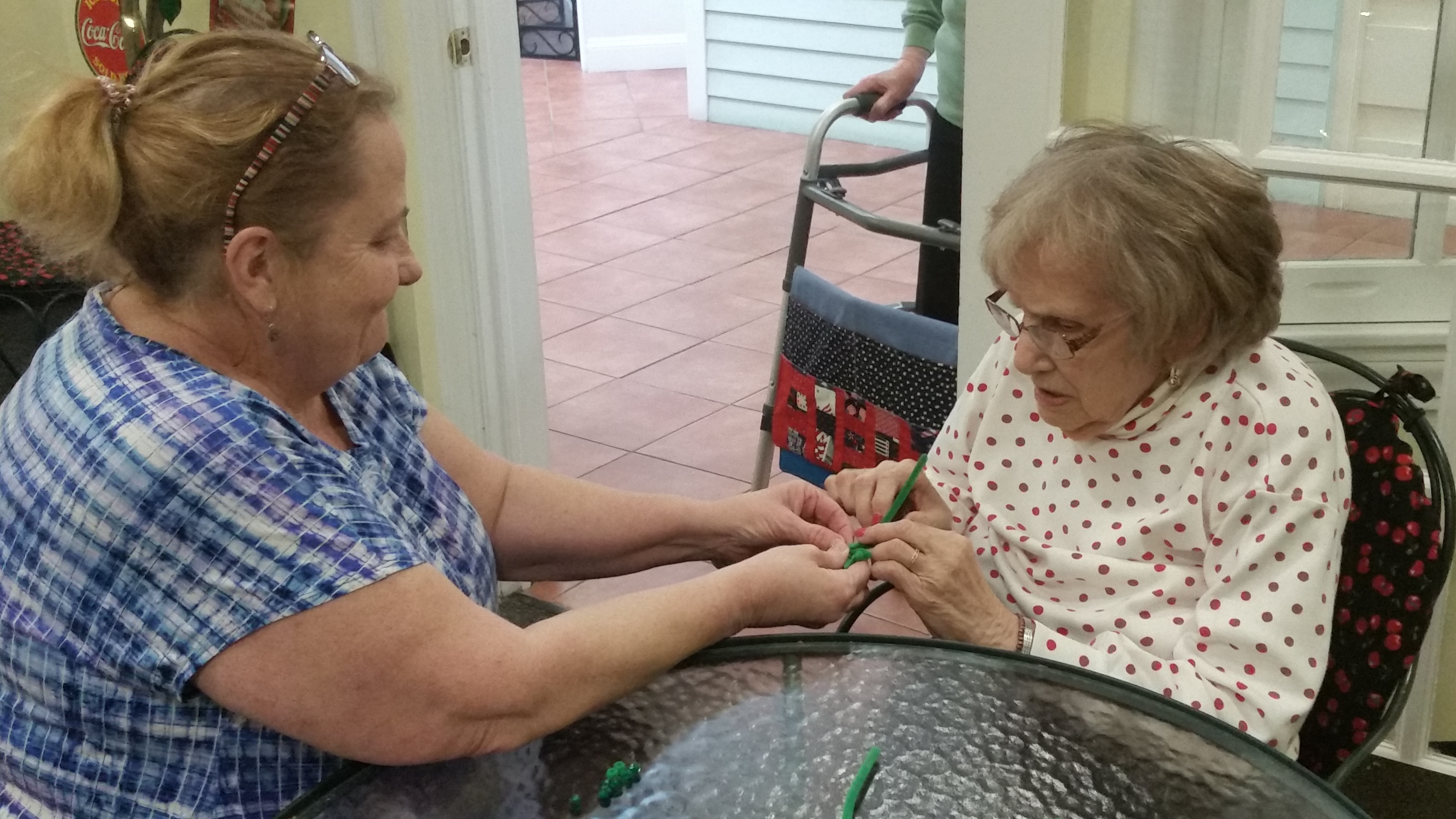 women making shamrock pin