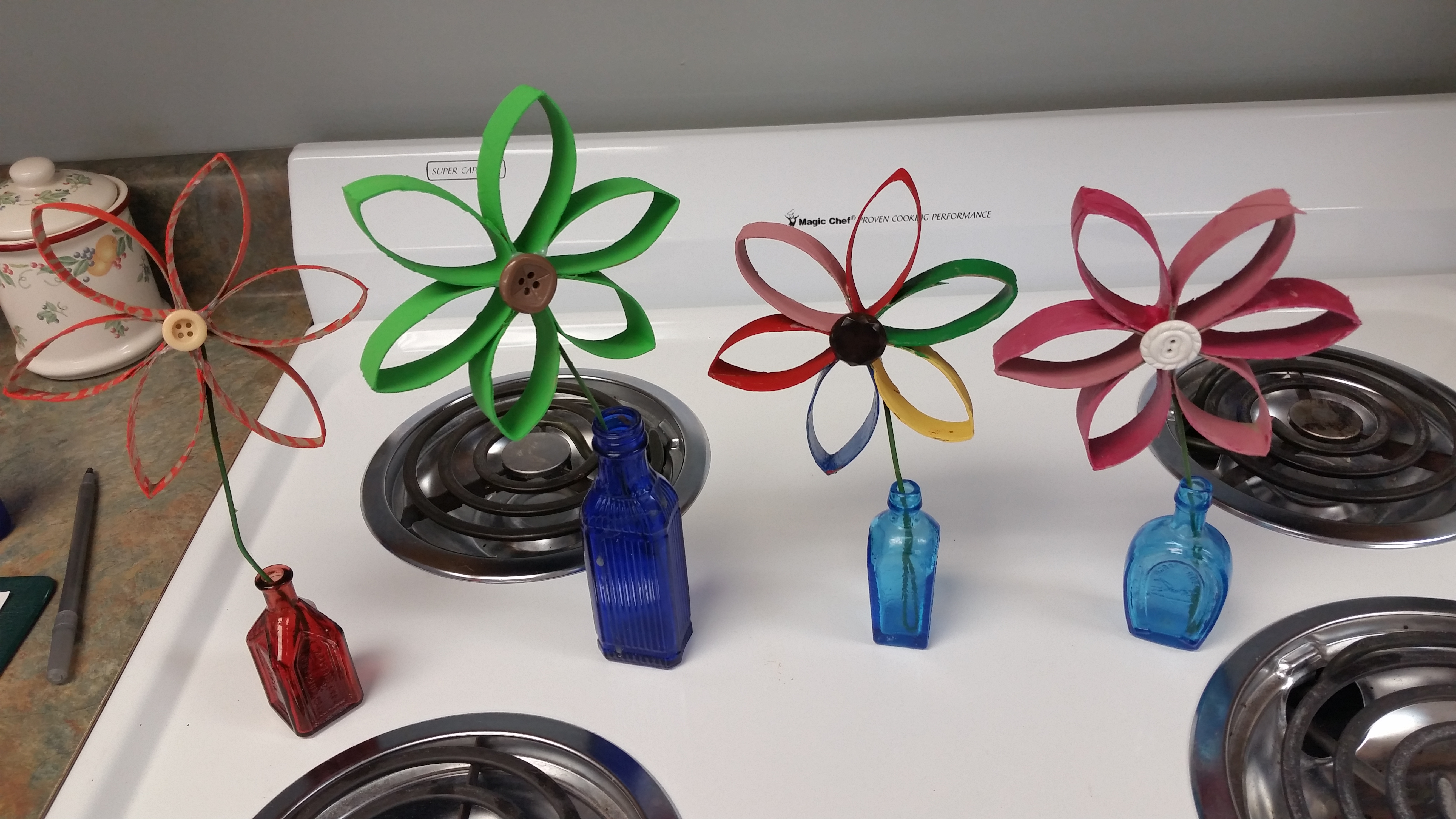 toilet paper roll flowers in bottles