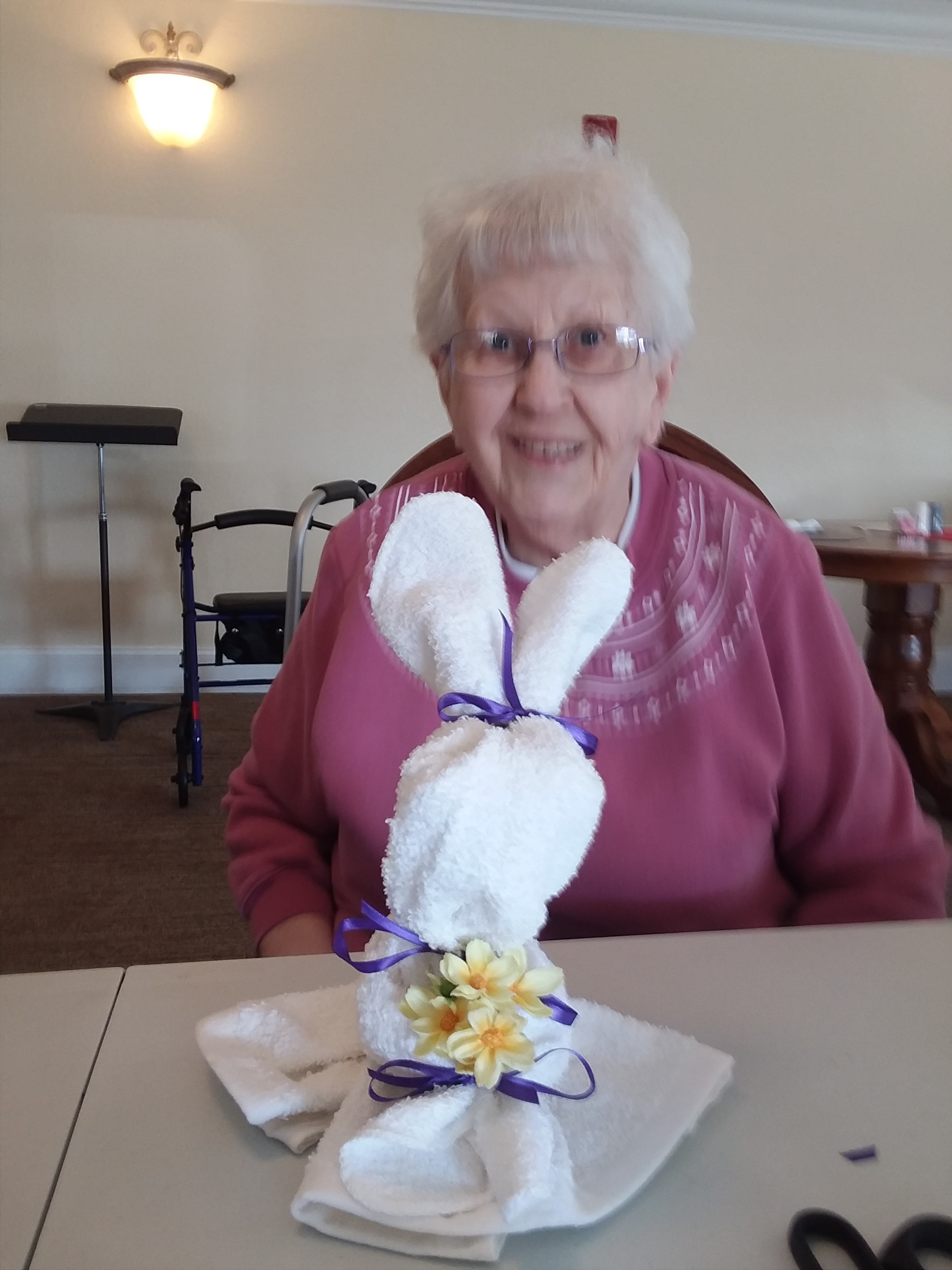 woman with bunny craft smiling at camera