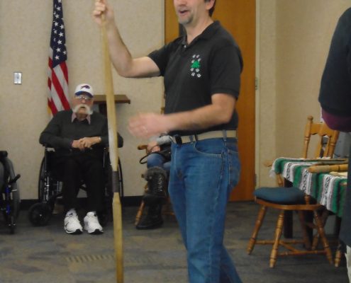 man displaying native american spear