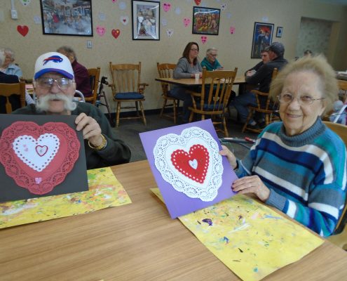 couple smiling with valentine's day decorations