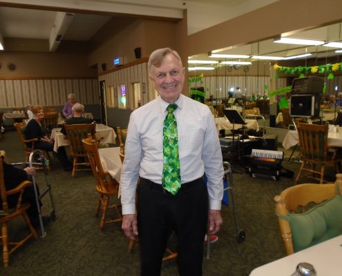 man in st patrick's day tie smiling