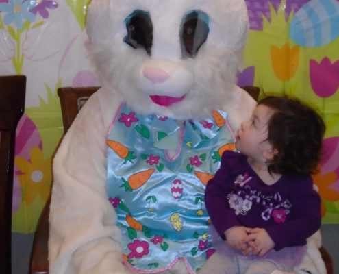child sitting on lap of easter bunny