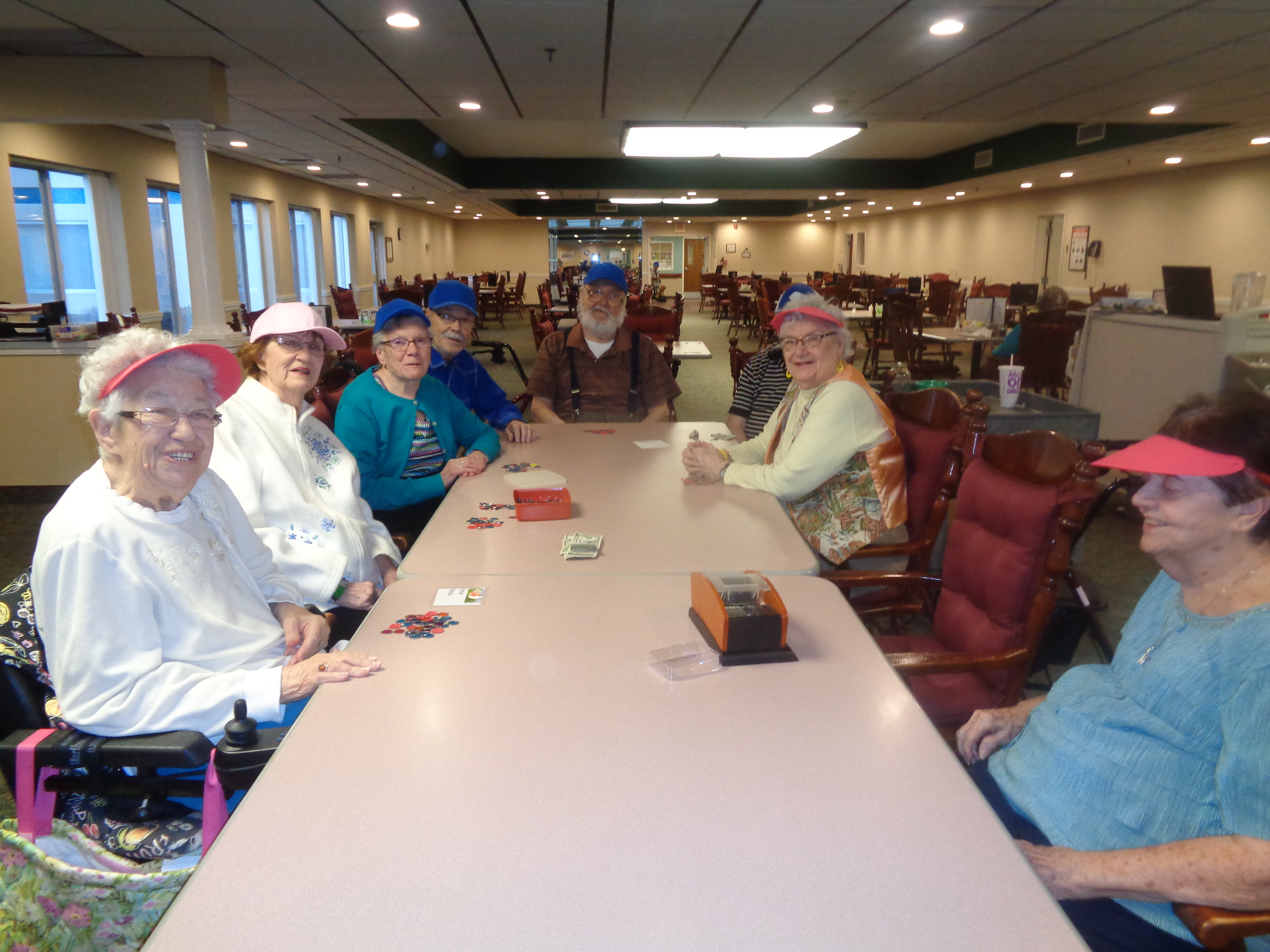 group smiling at poker table