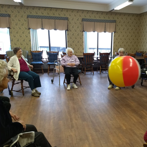 group in circle playing with beach ball