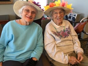 women in easter bonnets smiling at camera