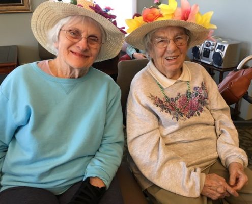 women in easter bonnets smiling at camera