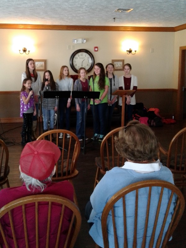 young women singing to audience